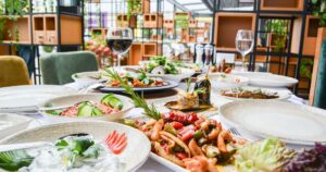 Restaurant table arranged with gourmet dishes, illustrating F&B marketing in Singapore.
