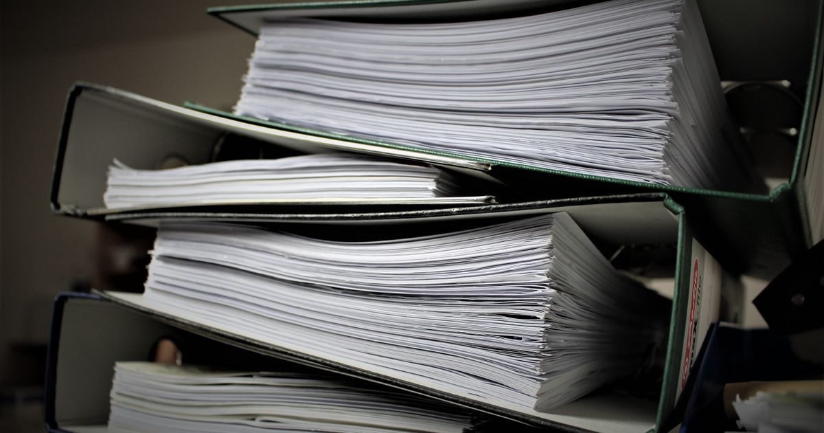 Stacked binders filled with documents, representing duplicate content across pages