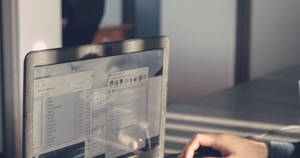 Person typing on a laptop in an office, representing setting up a first Google Ads campaign
