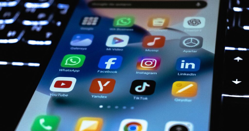 Close-up of a smartphone screen showing social media app icons, illustrating a comparison of Instagram, TikTok and LinkedIn in Singapore.