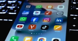 Close-up of a smartphone screen showing social media app icons, illustrating a comparison of Instagram, TikTok and LinkedIn in Singapore.