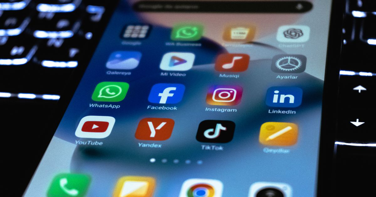 Close-up of a smartphone screen showing social media app icons, illustrating a comparison of Instagram, TikTok and LinkedIn in Singapore.