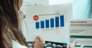 Person analysing financial graphs and return on investment reports, representing SEO ROI