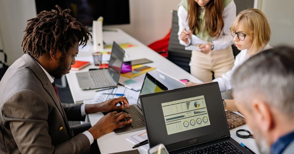 Marketing team reviewing campaign performance dashboards while planning Meta ad creative