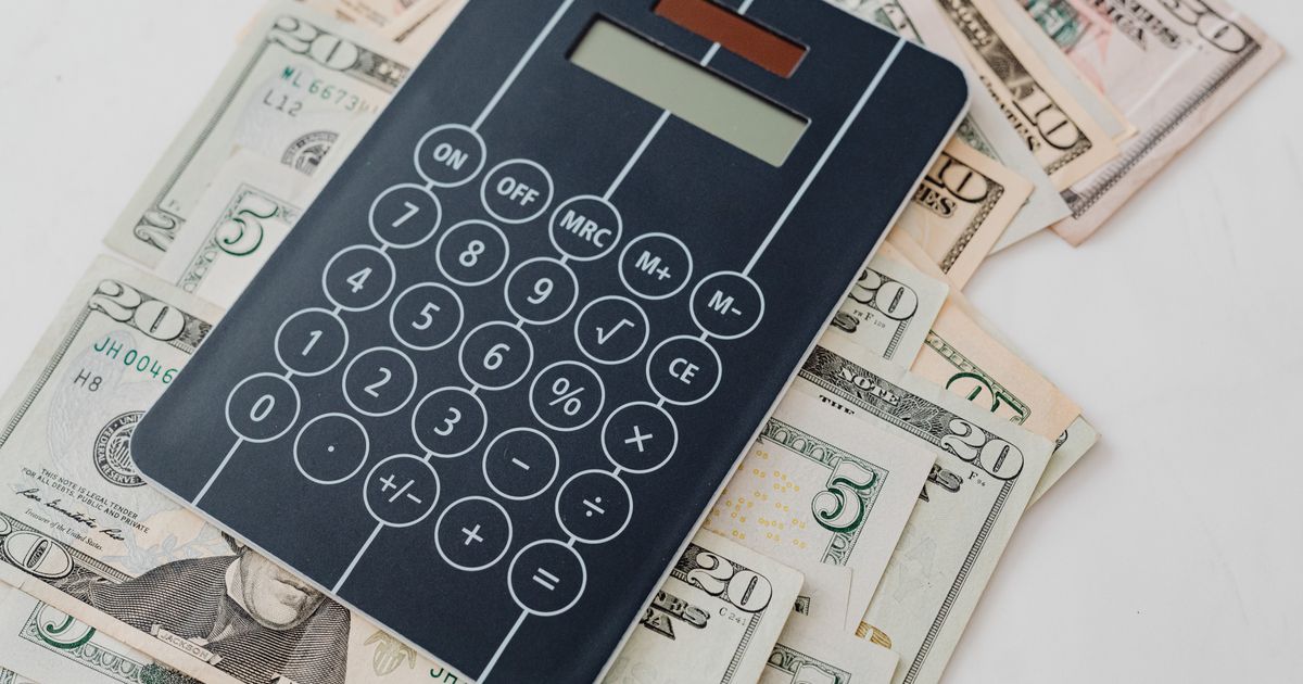 Calculator resting on banknotes, representing the cost of Meta advertising