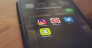 Smartphone displaying popular social media apps, representing Facebook and Instagram advertising