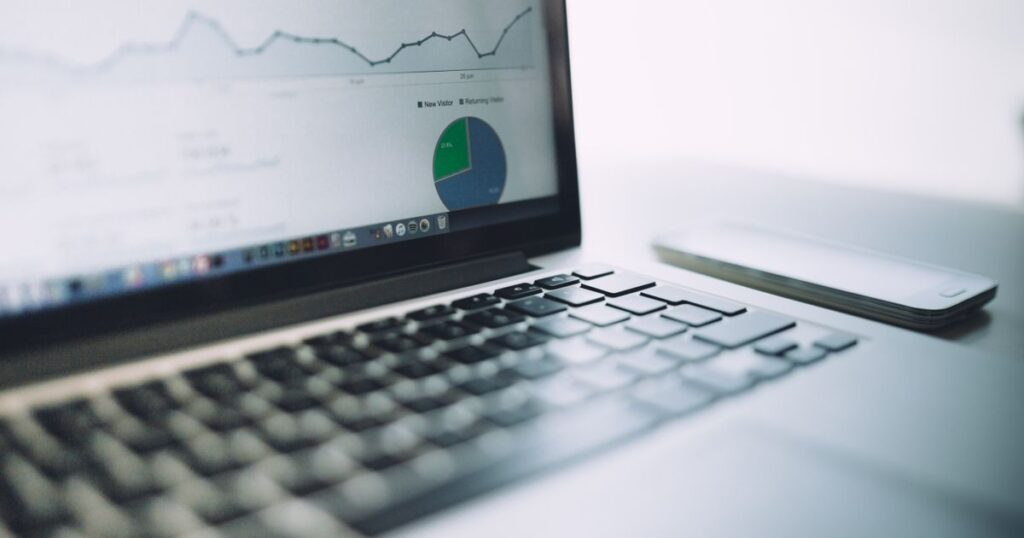 Laptop showing an analytics dashboard with charts, representing the Meta Business Manager interface
