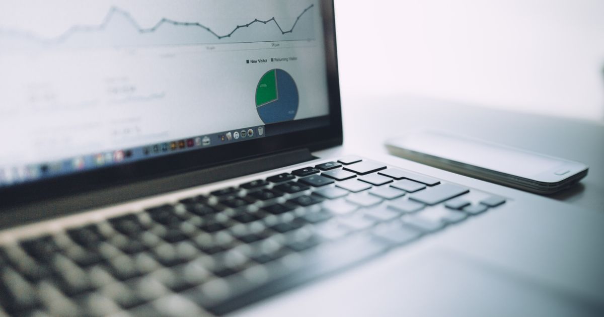 Laptop showing an analytics dashboard with charts, representing the Meta Business Manager interface