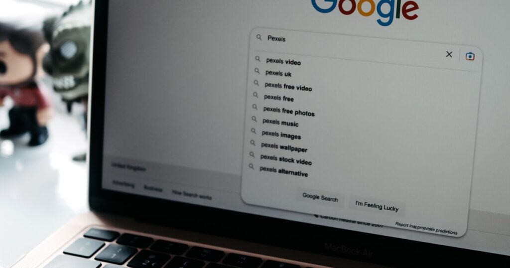 A laptop screen showing a Google search results page, representing search advertising demand capture
