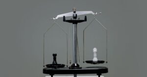 Chess pieces balanced on a scale, representing the choice between SEO and Google Ads