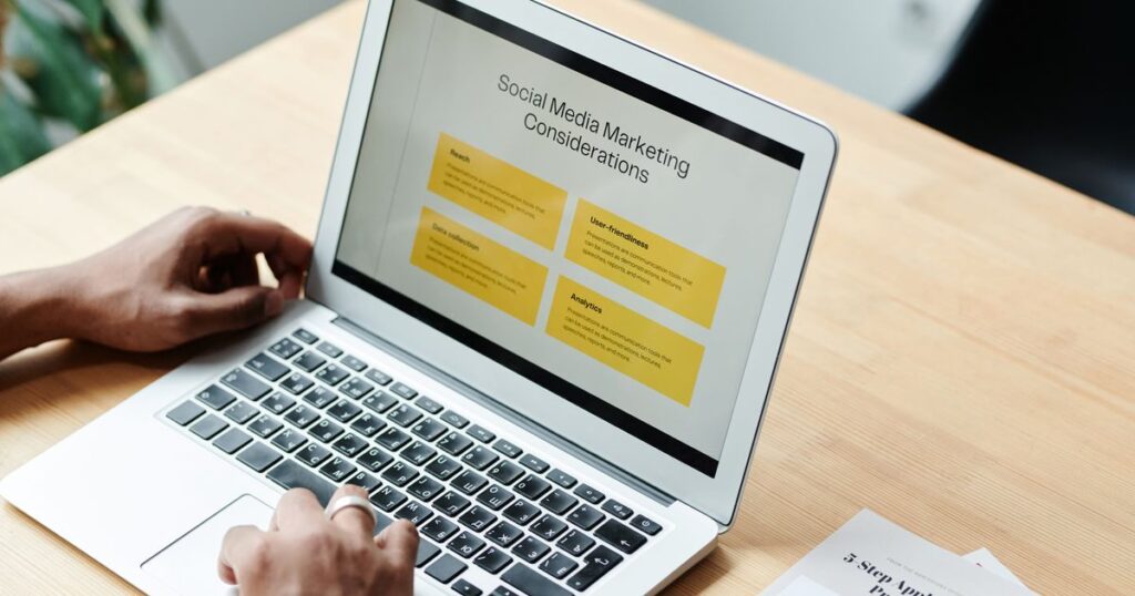 Marketer reviewing social media marketing performance on a laptop while planning an account audit.