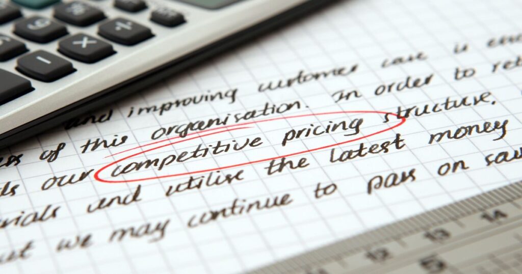 Calculator and handwritten notes on pricing strategy, illustrating social media management costs in Singapore.
