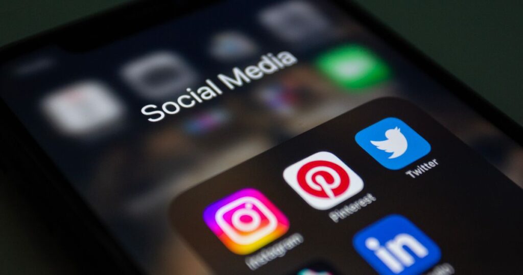 Smartphone screen showing social media apps including Instagram and TikTok, illustrating social media management in Singapore.