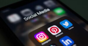 Smartphone screen showing social media apps including Instagram and TikTok, illustrating social media management in Singapore.