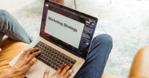 Marketer planning a campaign on a laptop showing a marketing strategy document