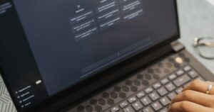 Close-up of a laptop screen showing an AI chat assistant interface while a person types