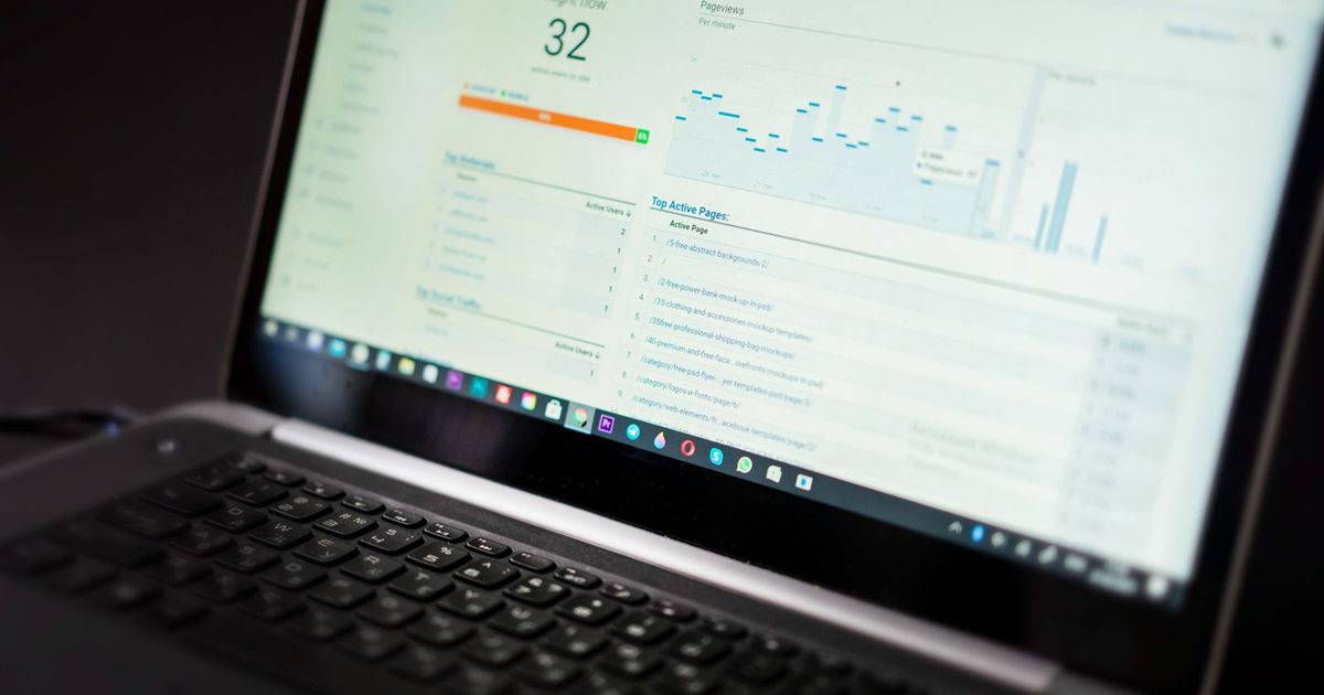 Laptop screen showing a live web analytics dashboard with traffic charts
