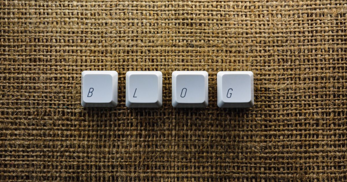 Keyboard keys arranged to spell the word blog on a textured surface.