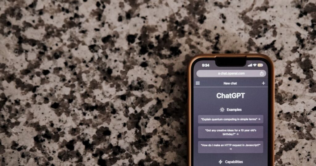 Smartphone on a stone counter showing the ChatGPT app open at a new chat