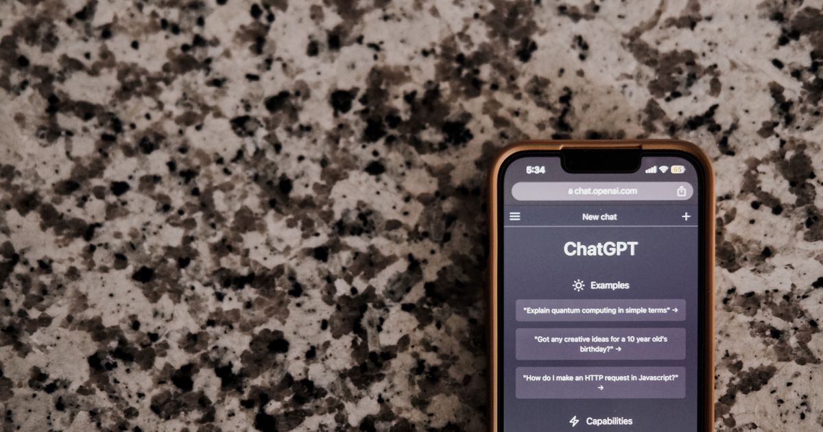 Smartphone on a stone counter showing the ChatGPT app open at a new chat