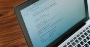 Google search results page open on a laptop screen on a wooden desk