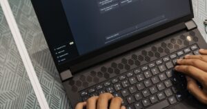 Marketer typing on a laptop with the ChatGPT chat interface open on screen