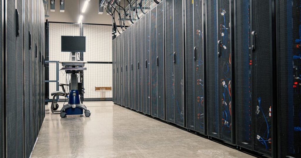 Steel cabinets of servers, networking equipment and cabling in a data centre, where crawler requests are logged.