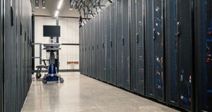 Steel cabinets of servers, networking equipment and cabling in a data centre, where crawler requests are logged.