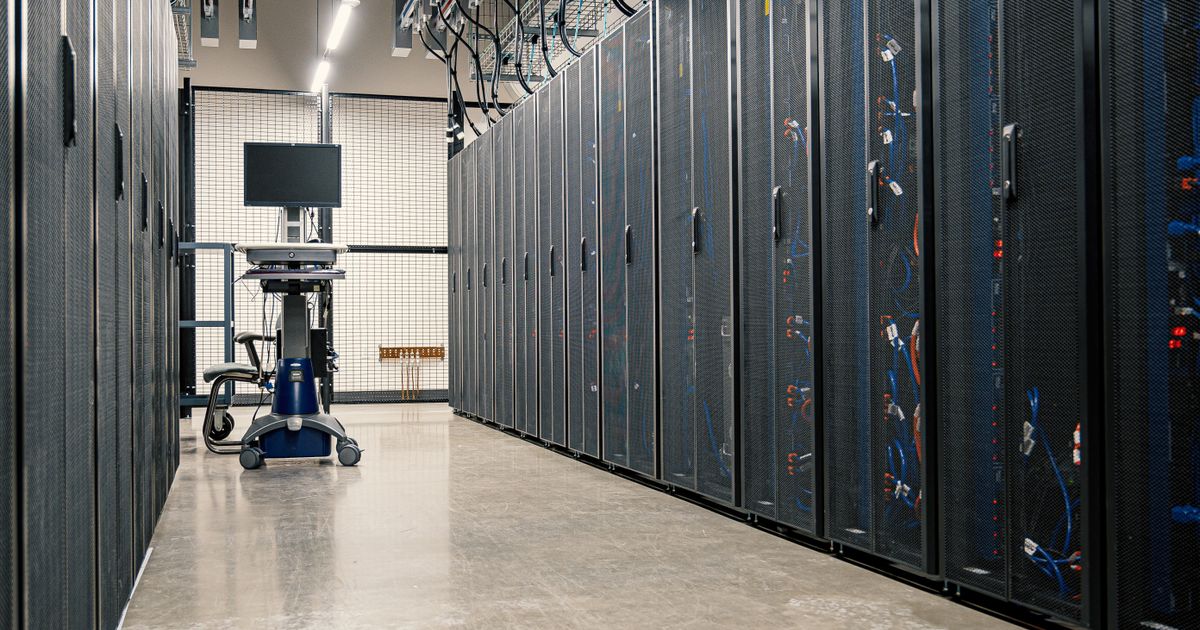 Steel cabinets of servers, networking equipment and cabling in a data centre, where crawler requests are logged.
