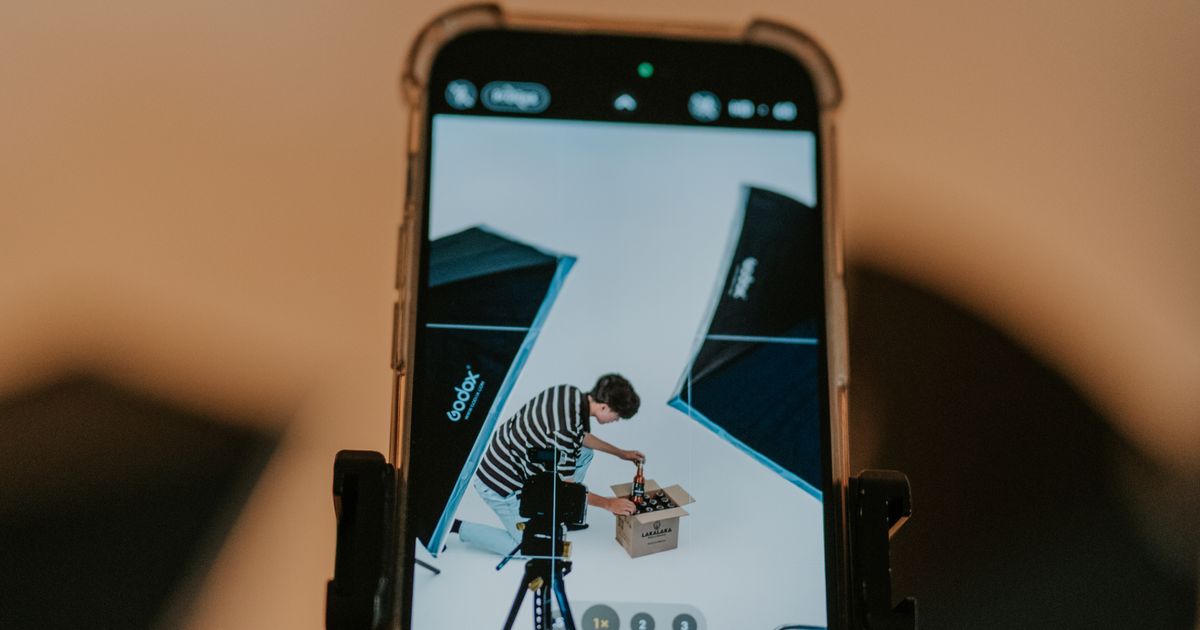 A smartphone mounted on a rig filming a product shoot in a lit studio for short-form video
