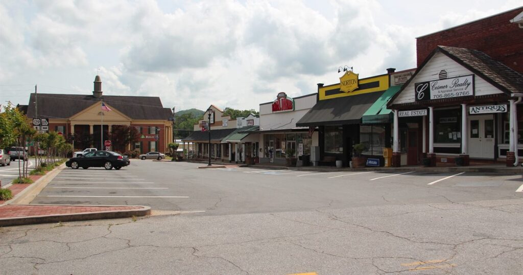 A row of neighbouring shopfronts with competing business names on their signs