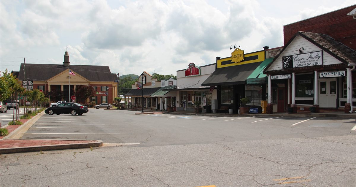 A row of neighbouring shopfronts with competing business names on their signs