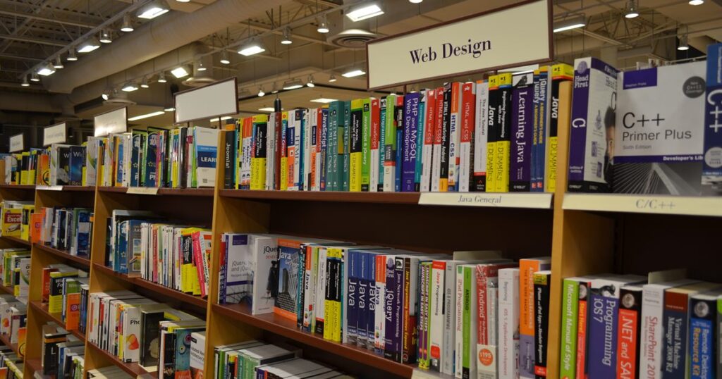 Web design and development reference books lined up on a shelf