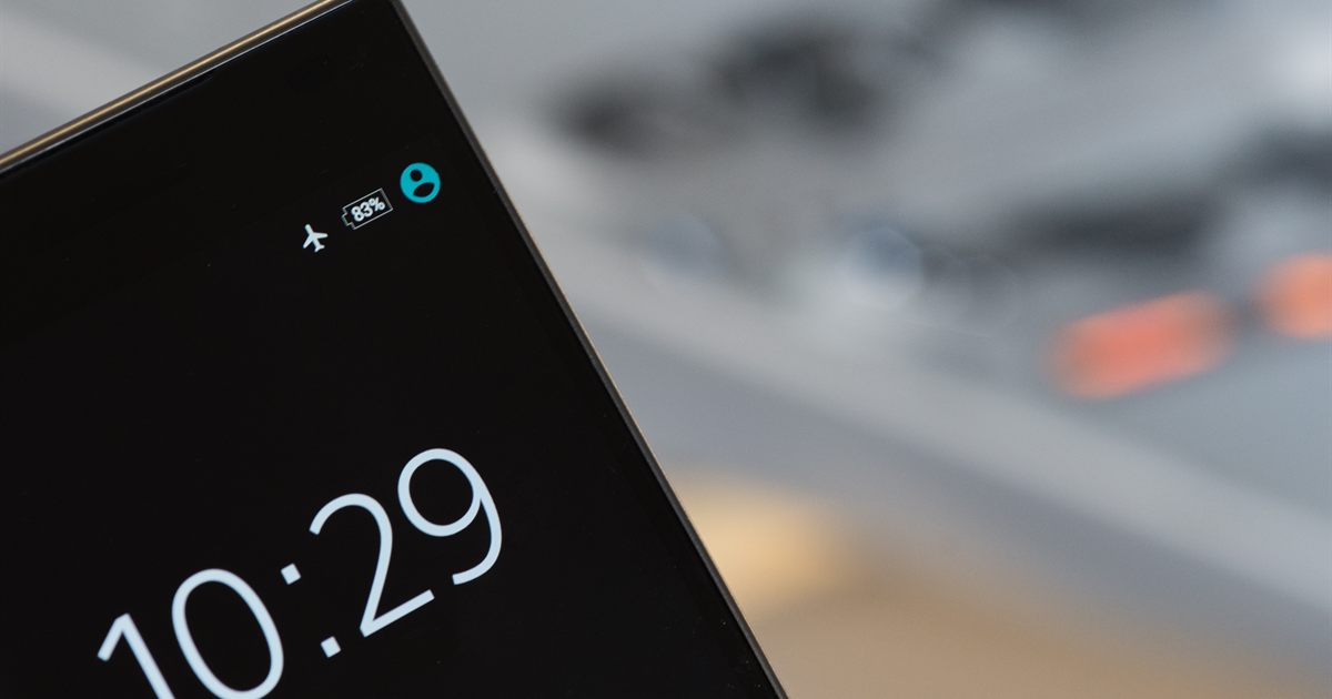 Close-up of a smartphone screen showing the lock screen clock, used to illustrate messaging-app marketing rules in Singapore