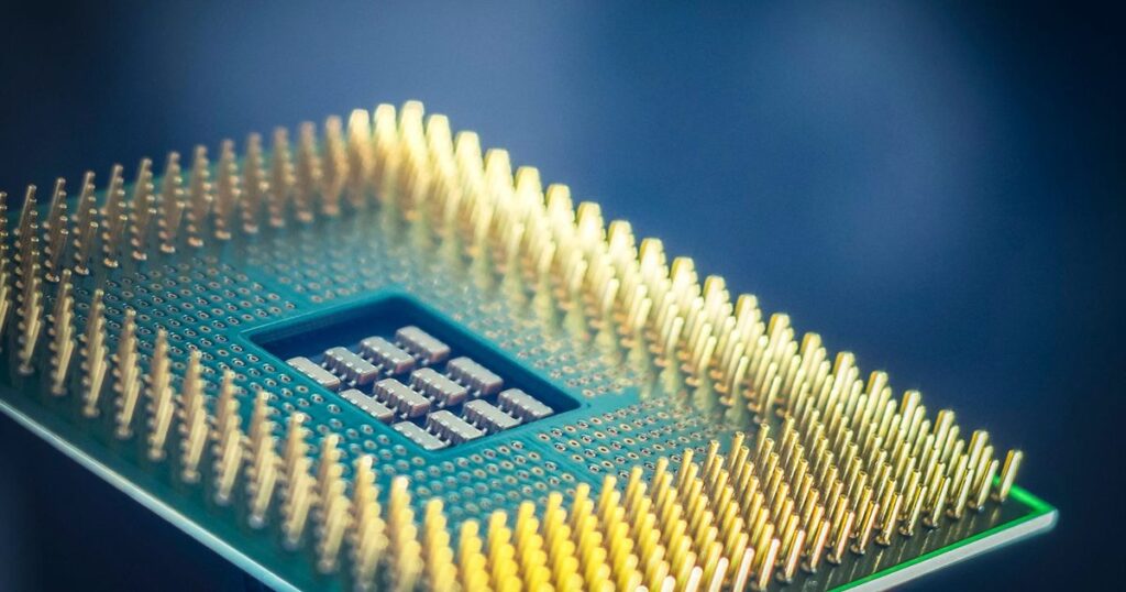 Macro shot of a computer processor chip with gold pins against a blue background, illustrating how Singapore advertising and consumer-protection rules treat AI-powered product claims.
