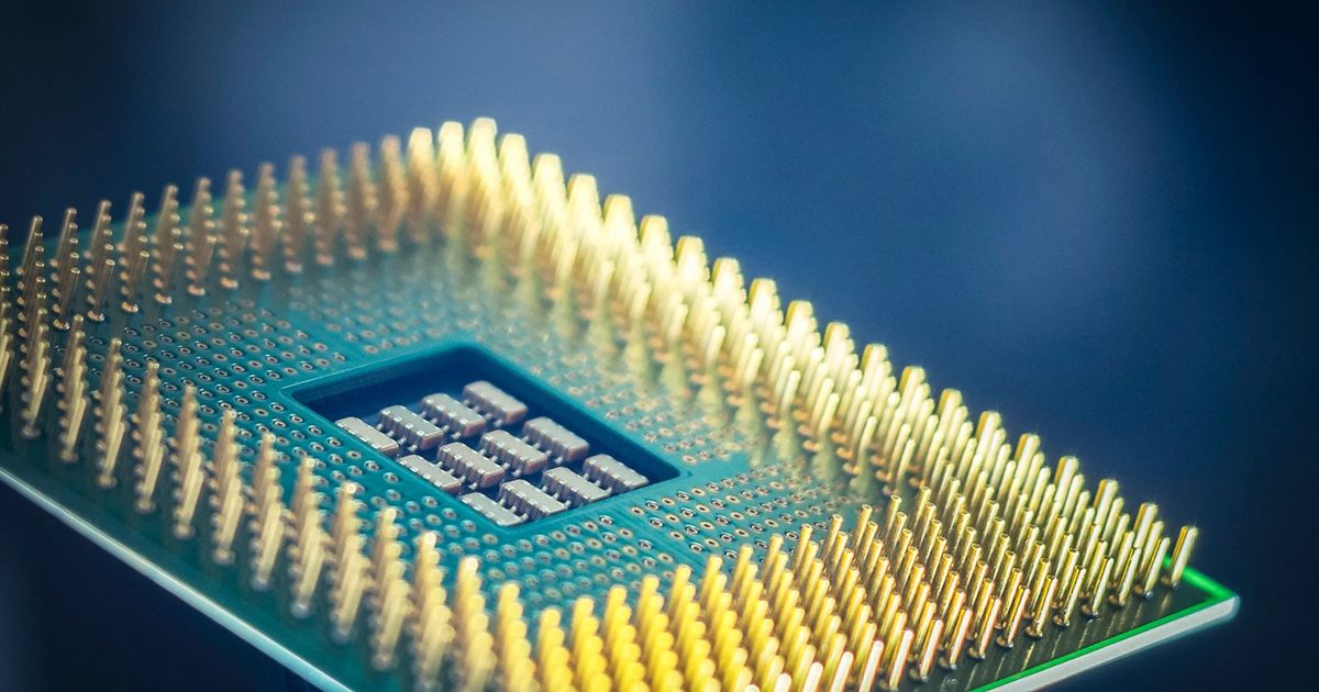 Macro shot of a computer processor chip with gold pins against a blue background, illustrating how Singapore advertising and consumer-protection rules treat AI-powered product claims.