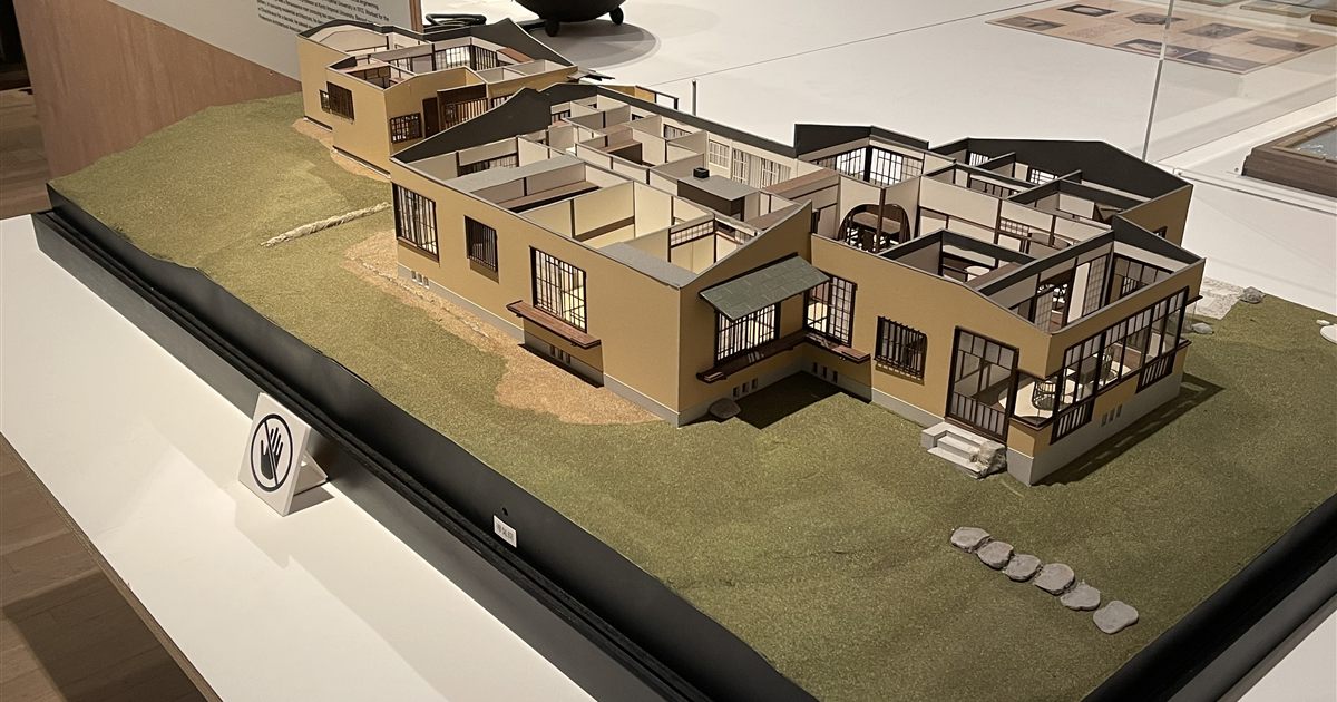 A detailed cut-away architectural scale model of a low-rise house on a landscaped base, illustrating the title and publicity rules for architects, engineers and accountants in Singapore.