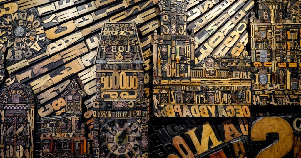 A wall of carved wooden letterpress type blocks in mixed sizes, illustrating how the words chosen for a business name or brand are restricted by law in Singapore.
