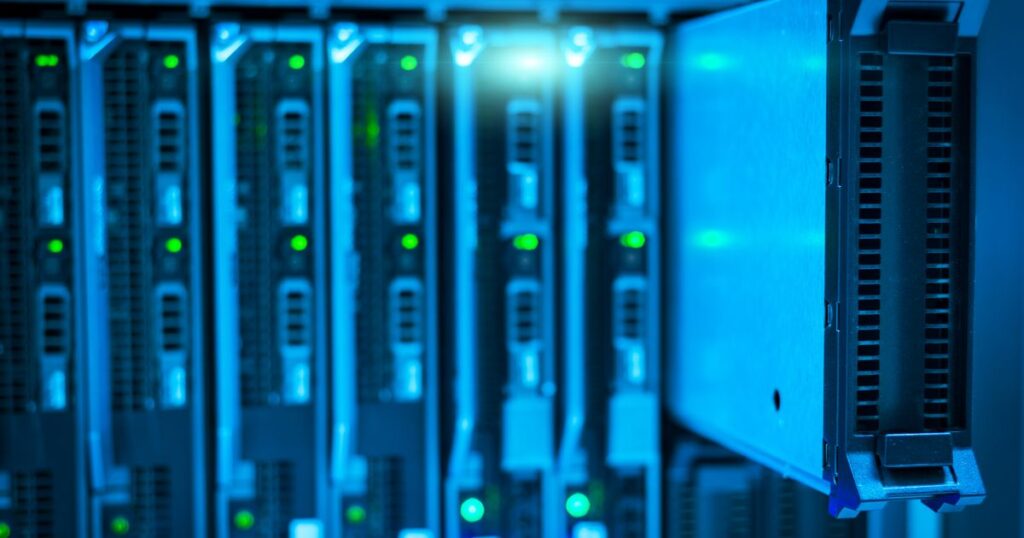 Close-up of blue-lit blade servers in a data centre rack, illustrating the licensing and claims rules for marketing cybersecurity services and devices in Singapore.