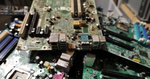 Pile of discarded computer circuit boards awaiting recycling, illustrating Singapore retailers' e-waste take-back duties under the Resource Sustainability Act.